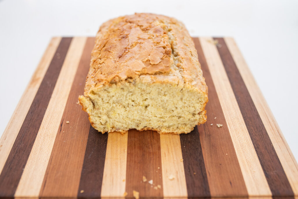 Cut banana bread with sugar topping on a board